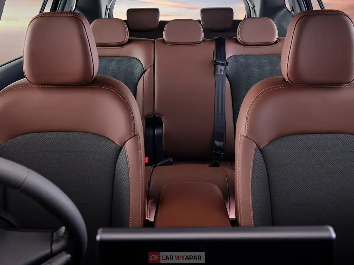 Close-up of luxurious brown leather car seats showing detailed stitching and headrests.